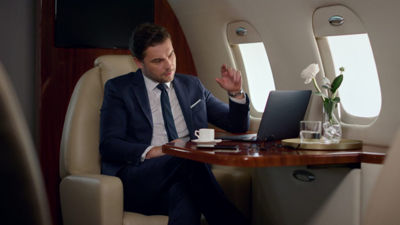 serious-businessman-videocalling-partner-private-jet-focused-ceo-talk-online